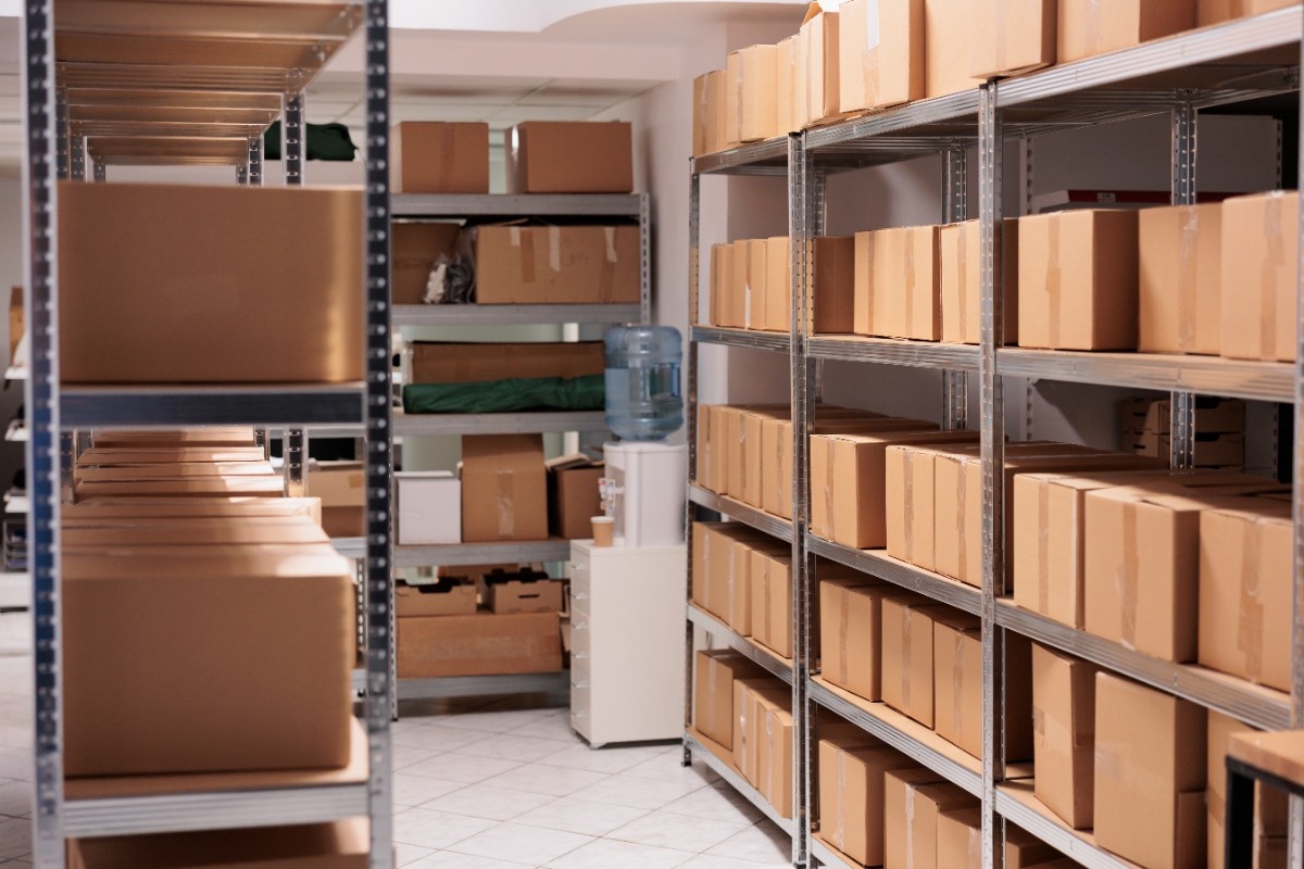 storehouse-interior-with-stacked-cardboard-boxes-tall-metal-racks-goods-cardboard-boxes-shelves-ready-transportration-industrial-warehouse-building-with-nobody-inside (1)